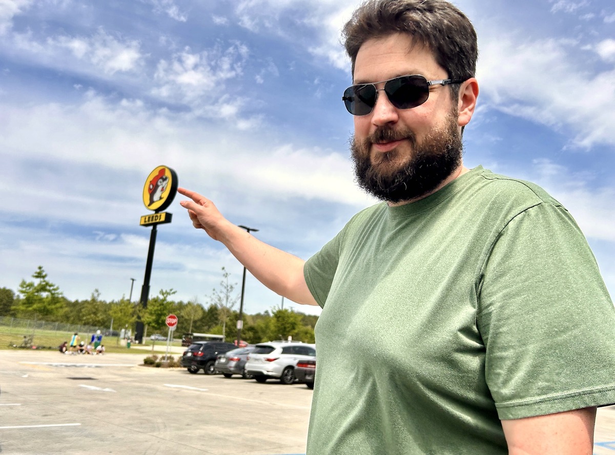 pointing at the Buc-ee's Sign